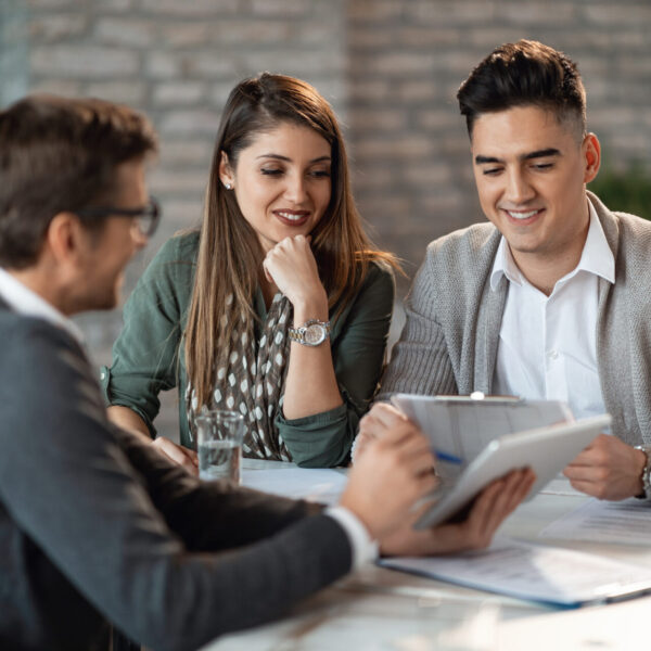 Young happy couple having consultations with bank manager on a meeting in the office.